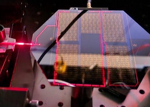 An image of a quantum photonic silicon nitride chip with a coupled light source, manufactured by LioniX International