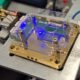 The full assembly of the AR/VR prototype is demonstrated. Using a custom PCB, the chip is assembled with all components on a submount. The diodes and heaters are then wirebonded on to the PCB to drive the functional chip electronically. In this picture, the modulation of the blue diode is shown.