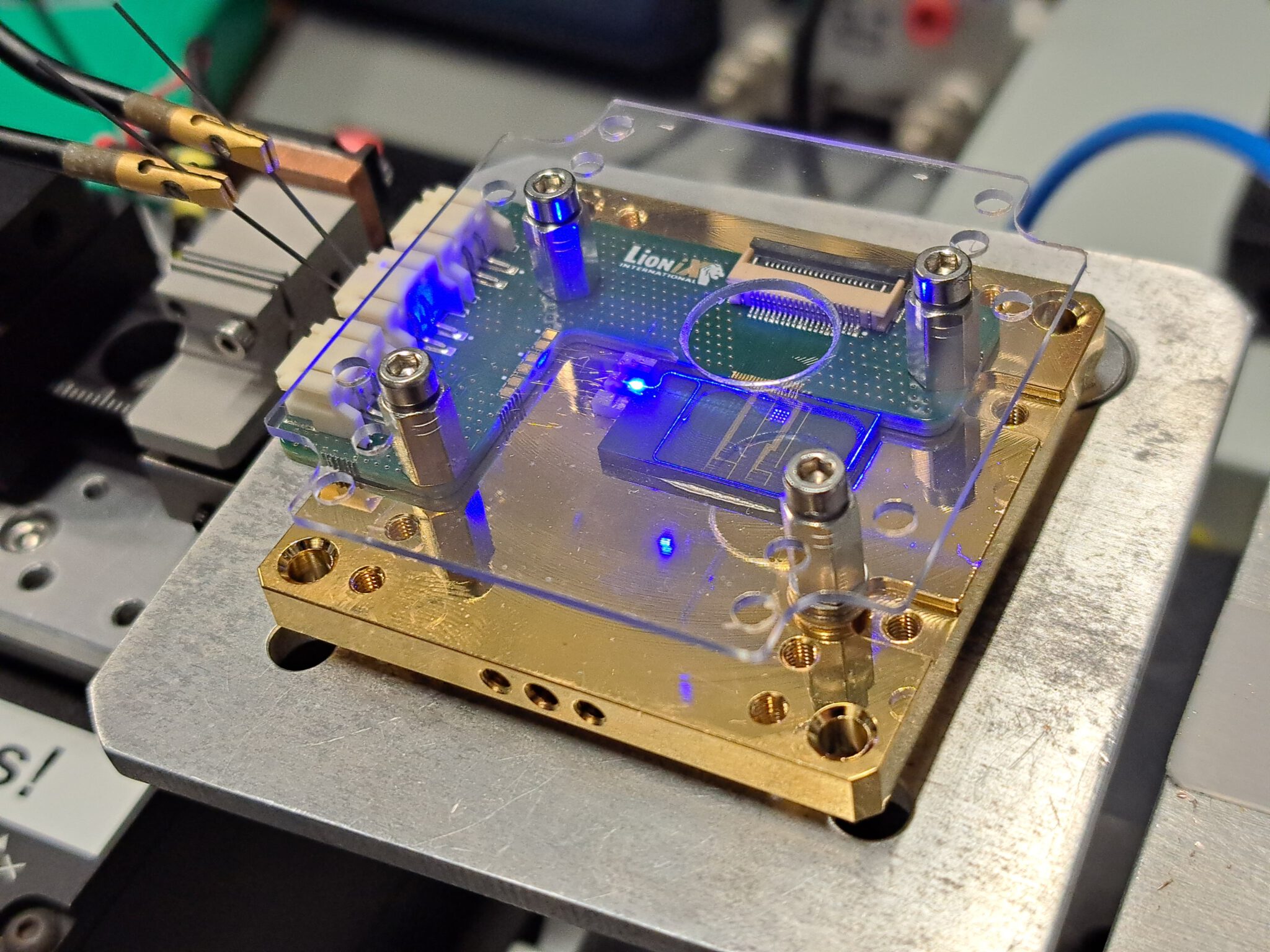 The full assembly of the AR/VR prototype is demonstrated. Using a custom PCB, the chip is assembled with all components on a submount. The diodes and heaters are then wirebonded on to the PCB to drive the functional chip electronically. In this picture, the modulation of the blue diode is shown.